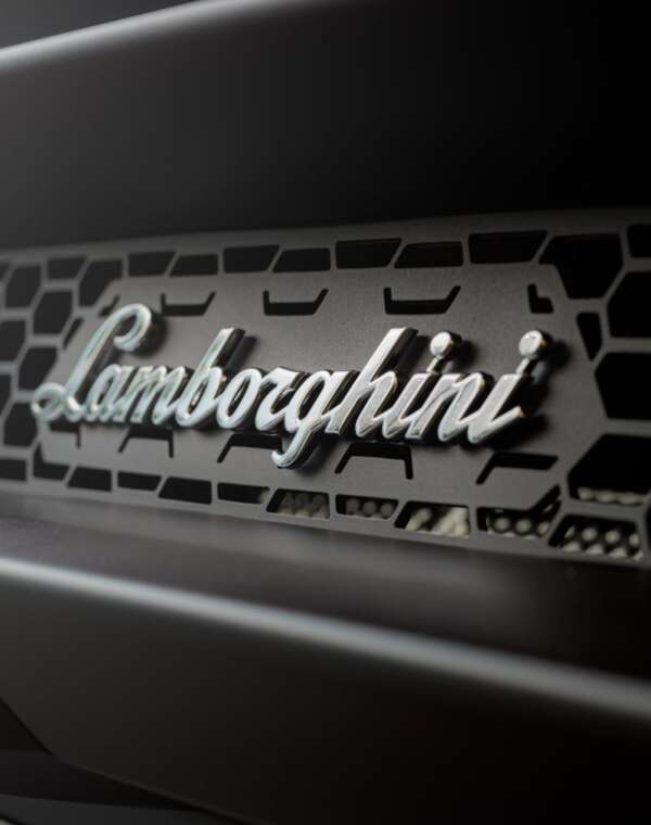 Close-up of a Lamborghini Huracan grille showcasing the luxury sports car emblem.